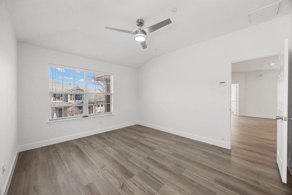 14815 Avery Ranch Boulevard, Unit 1701 Austin, TX 78717 - Photo 16 of 24 an empty room with wooden floor and windows