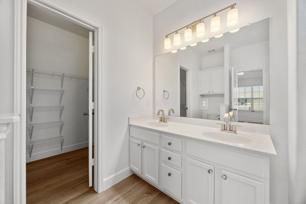 14815 Avery Ranch Boulevard, Unit 1701 Austin, TX 78717 - Photo 18 of 24 a bathroom with double vanity sink and a mirror