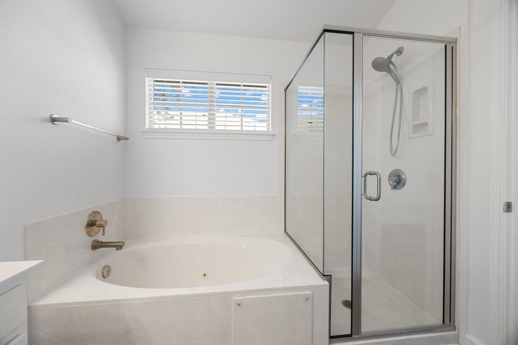 14815 Avery Ranch Boulevard, Unit 1701 Austin, TX 78717 - Photo 21 of 24 a bathroom with a bathtub and a shower