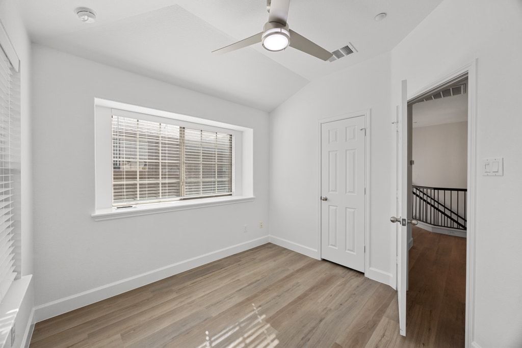 14815 Avery Ranch Boulevard, Unit 1701 Austin, TX 78717 - Photo 23 of 24 a view of an empty room with a window and wooden floor
