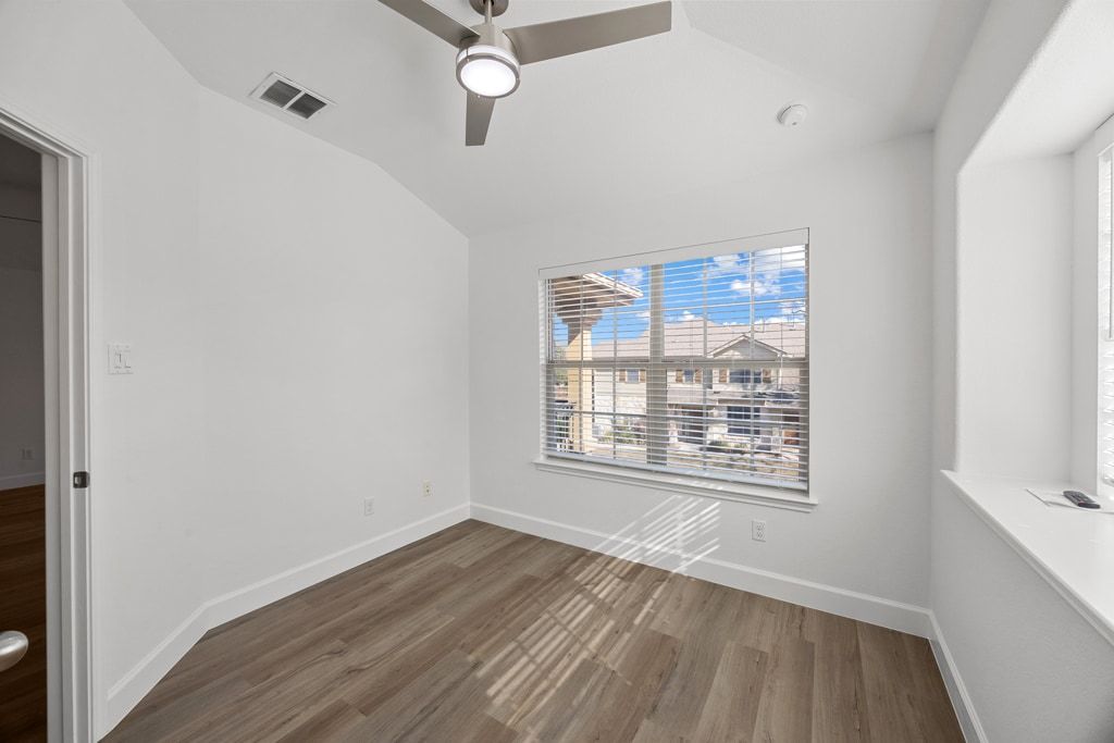 14815 Avery Ranch Boulevard, Unit 1701 Austin, TX 78717 - Photo 24 of 24 an empty room with wooden floor and windows