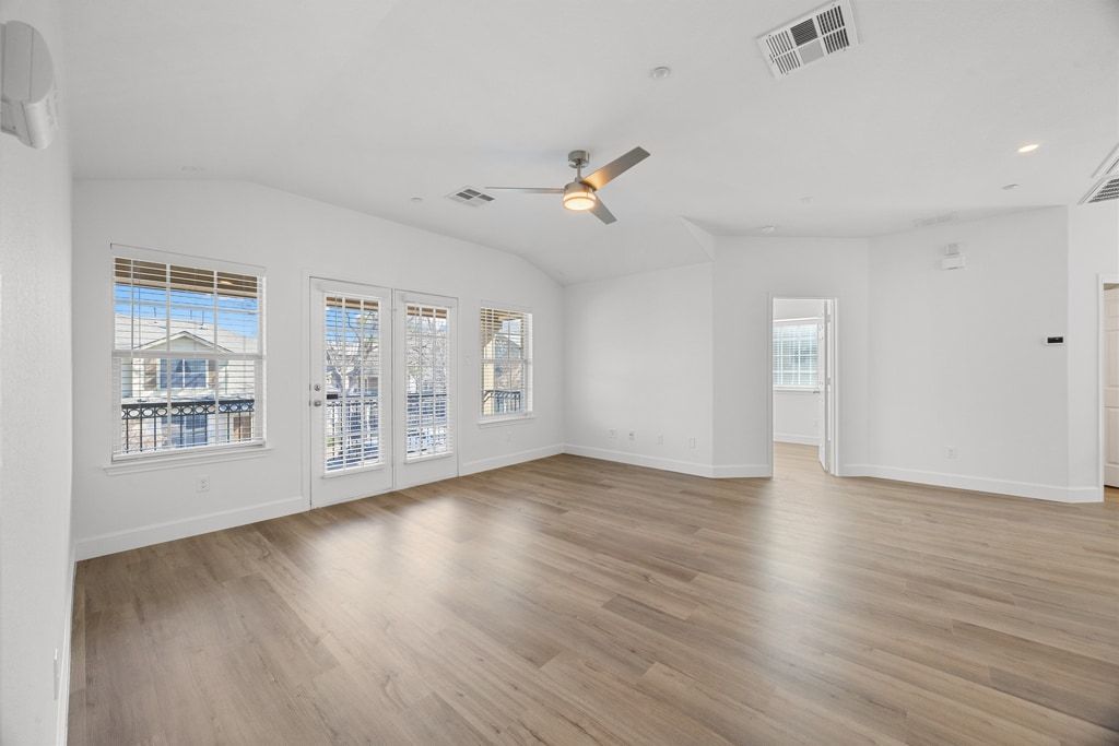 14815 Avery Ranch Boulevard, Unit 1701 Austin, TX 78717 - Photo 7 of 24 a view of an empty room with a window and wooden floor
