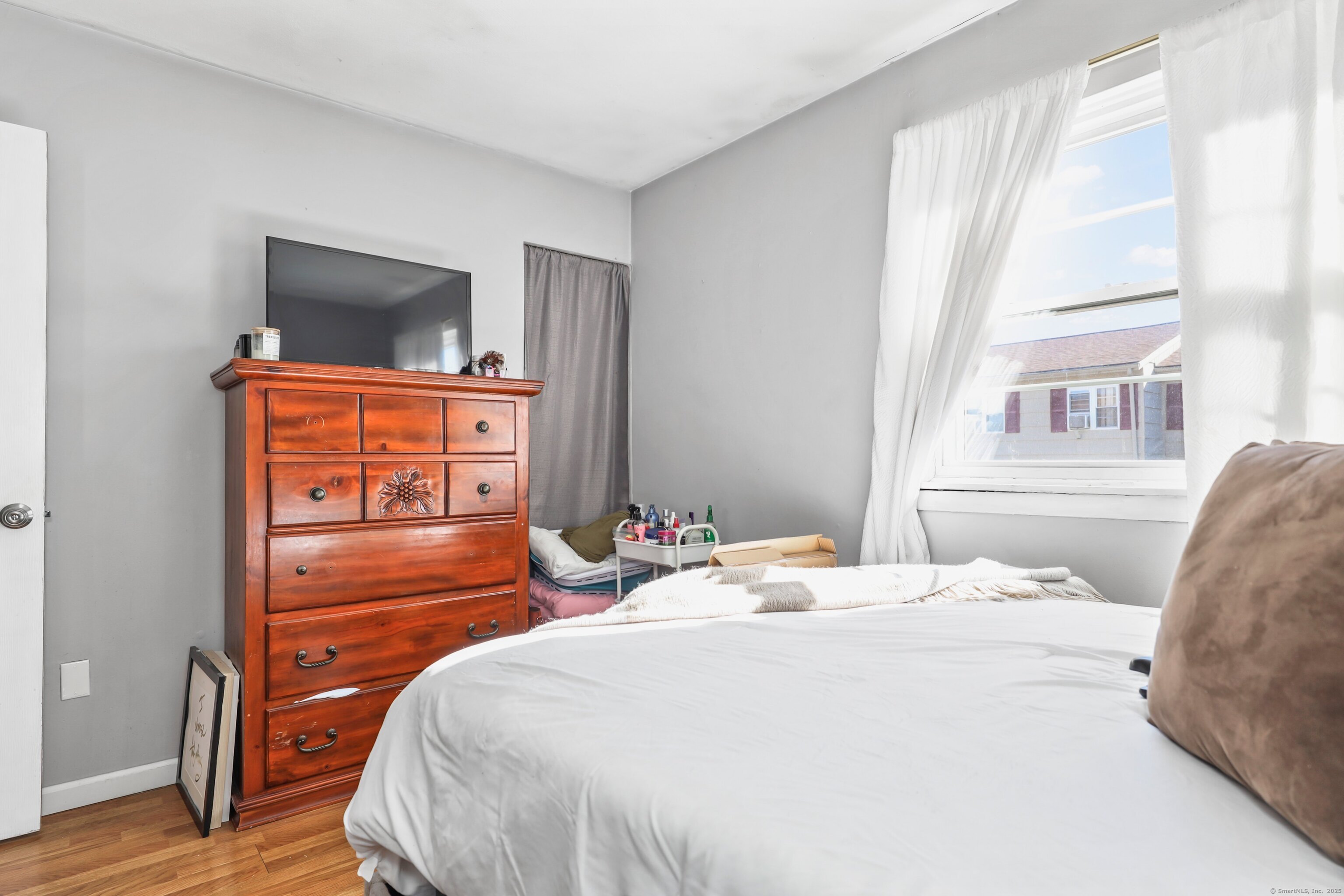 40 Ridge Road, Unit 3 Naugatuck, CT 06770 - Photo 11 of 15 a bedroom with a bed and a flat tv screen on dresser