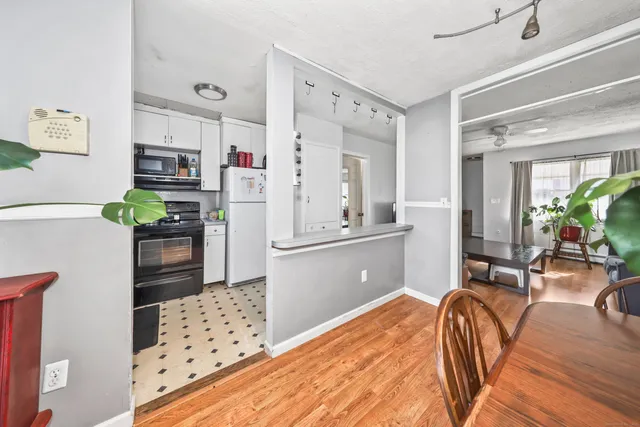 a kitchen with stainless steel appliances kitchen island granite countertop a refrigerator and a stove top oven