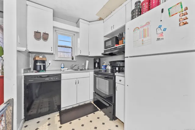 a kitchen with stainless steel appliances a refrigerator sink and cabinets