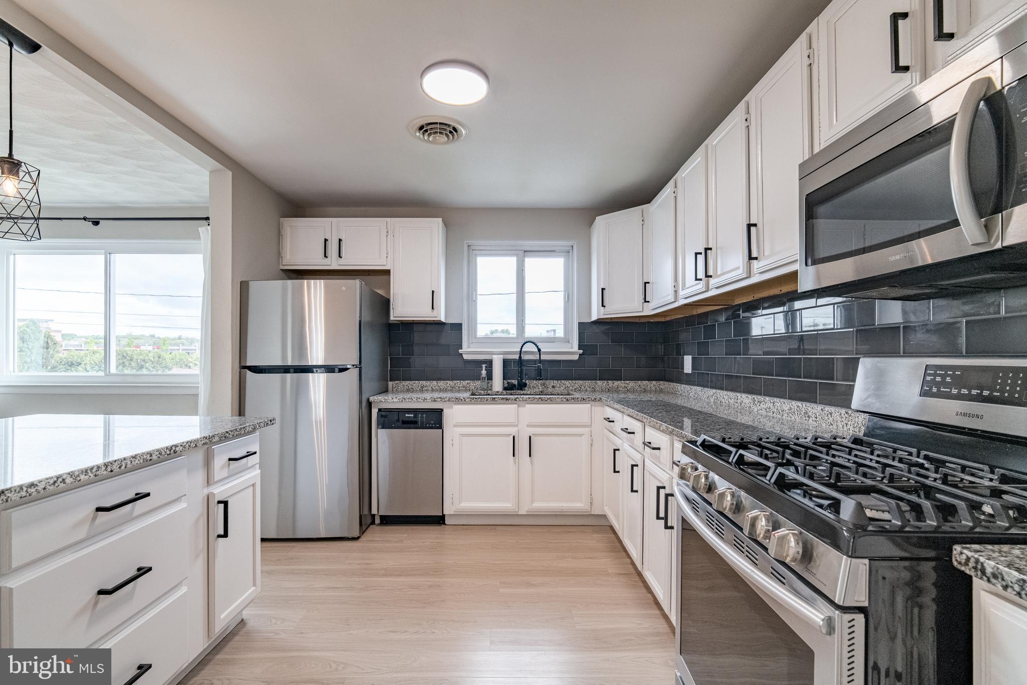 907 Marbrook Lane York, PA 17404 - Photo 11 of 33 a kitchen with white cabinets and appliances