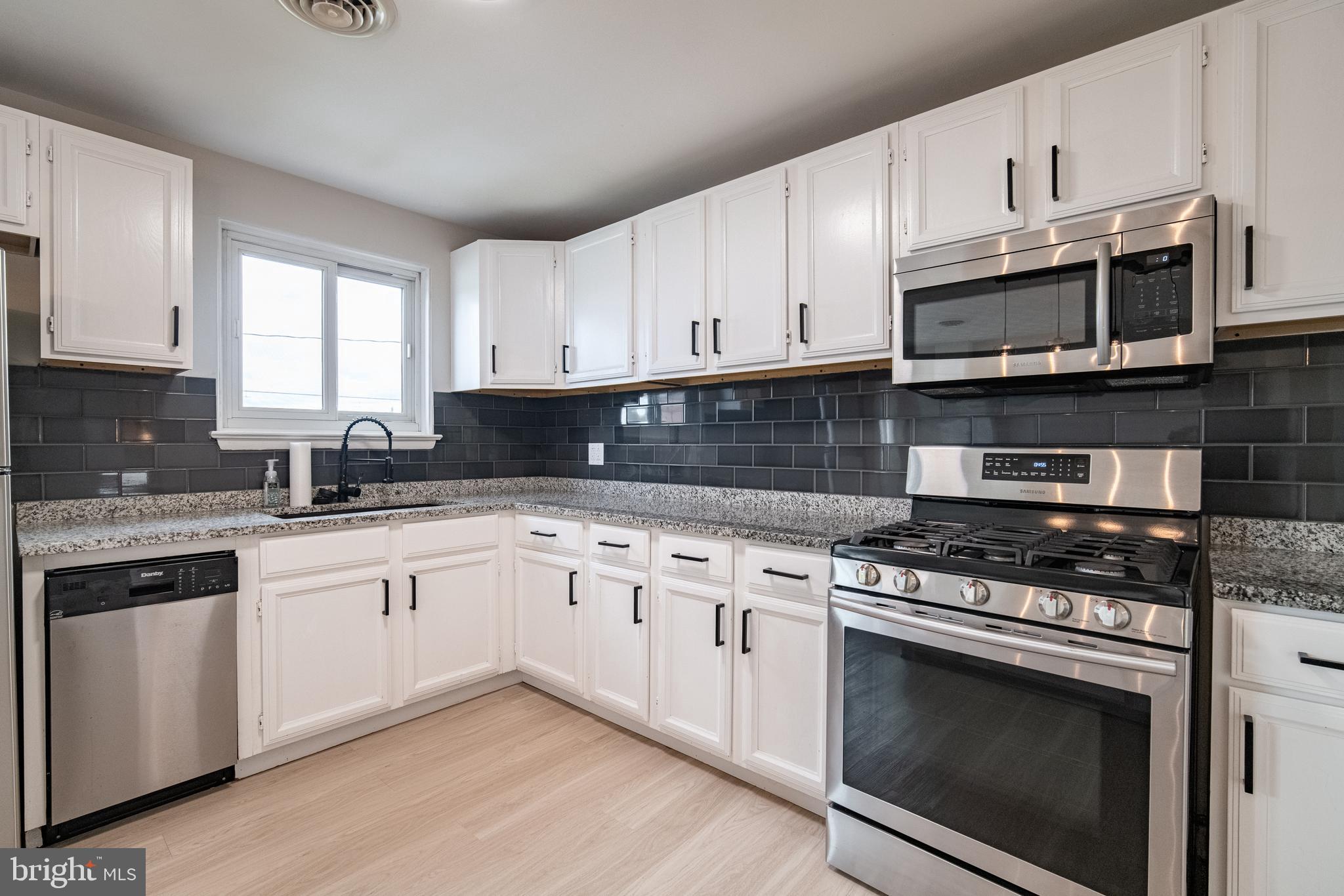 907 Marbrook Lane York, PA 17404 - Photo 12 of 33 a kitchen with stainless steel appliances granite countertop grey cabinets a stove a sink and dishwasher