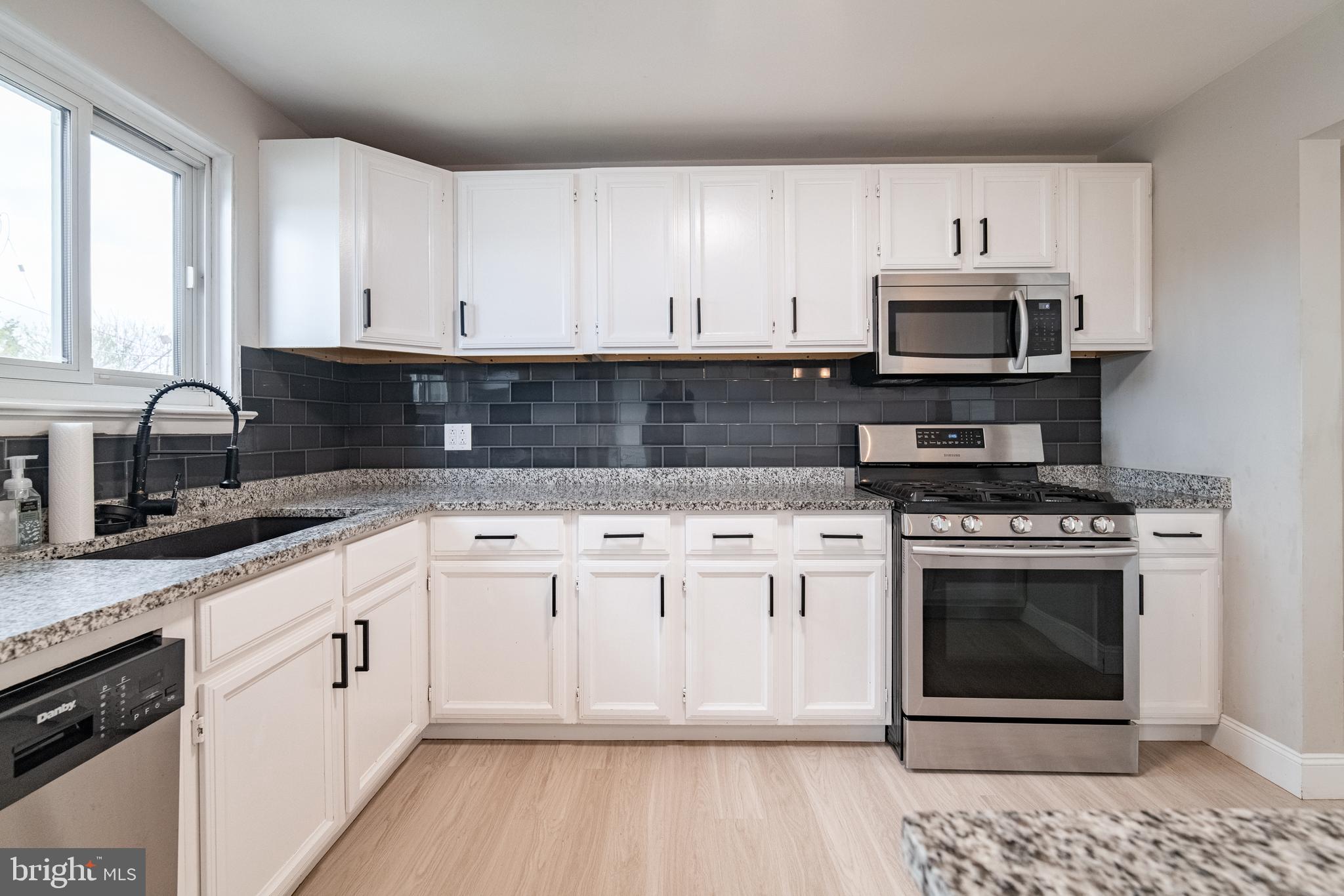 907 Marbrook Lane York, PA 17404 - Photo 13 of 33 a kitchen with stainless steel appliances granite countertop a stove a sink and a microwave