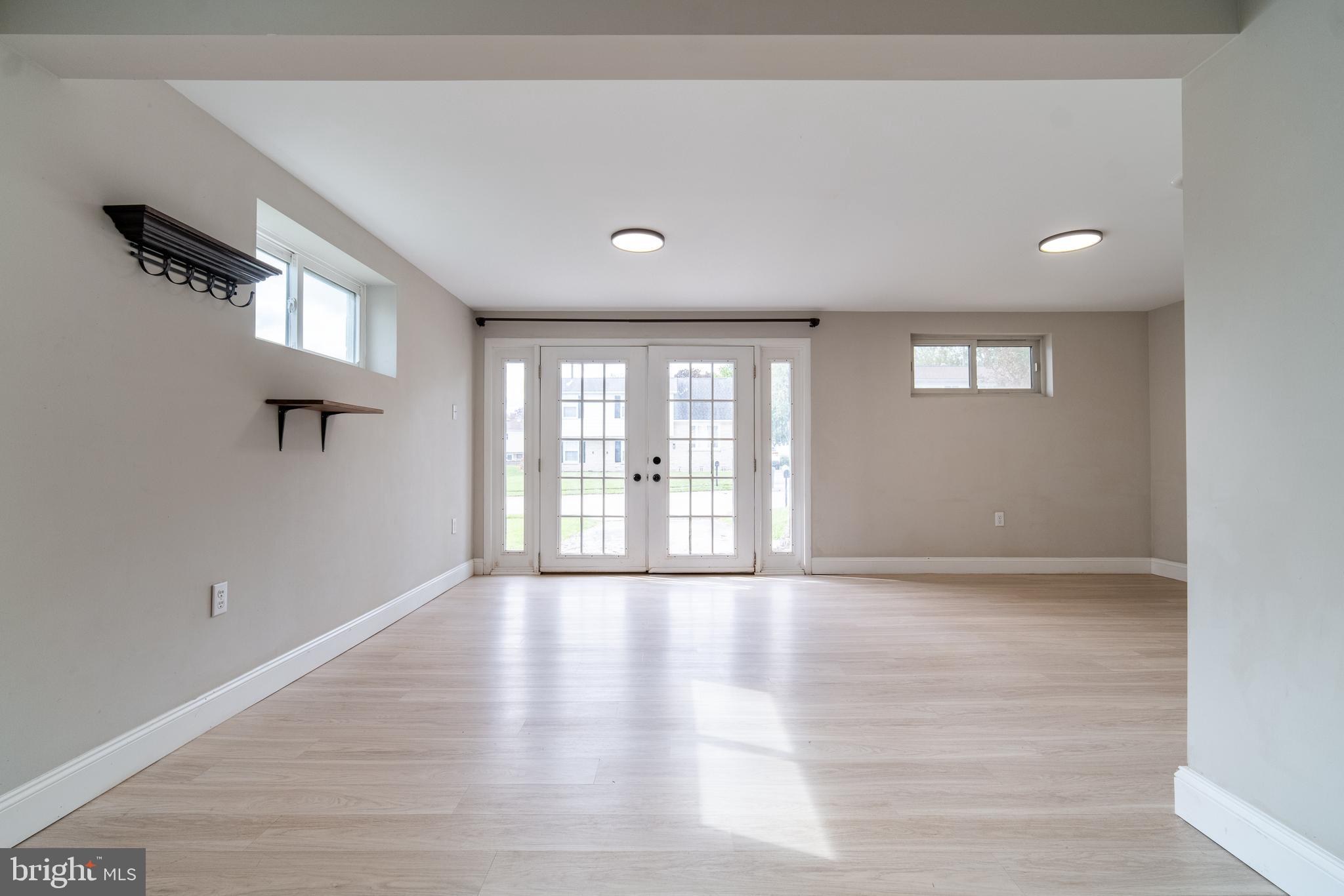 907 Marbrook Lane York, PA 17404 - Photo 27 of 33 a view of an empty room with a window and wooden floor