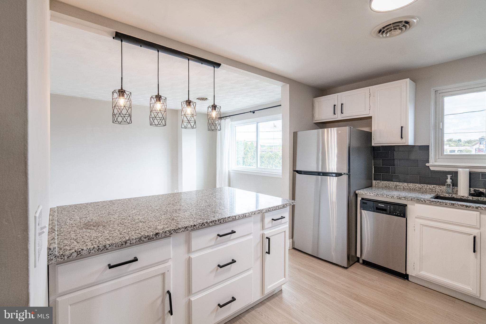 907 Marbrook Lane York, PA 17404 - Photo 10 of 33 a kitchen with refrigerator cabinets and wooden floor