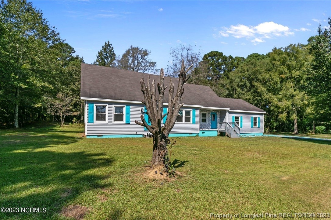 6243 Sisk Culbreth Road Godwin, NC 28344 - Photo 30 of 32 a front view of a house with garden