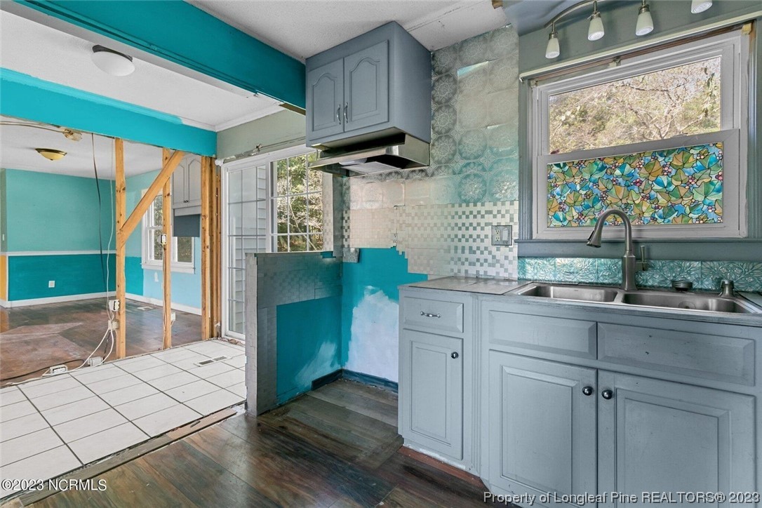 6243 Sisk Culbreth Road Godwin, NC 28344 - Photo 8 of 32 a kitchen with a refrigerator and a sink