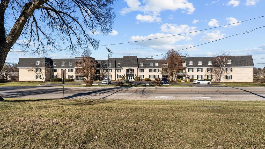 5548 Spring Brook Road, Unit 310 Rockford, IL 61114 - Photo 1 of 41 a view of a building with a yard