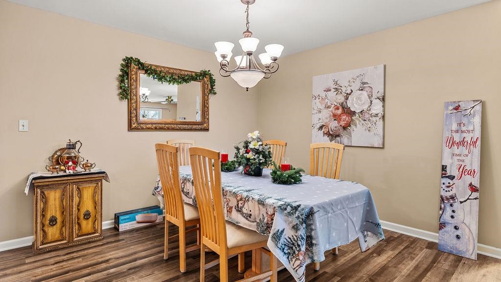 5548 Spring Brook Road, Unit 310 Rockford, IL 61114 - Photo 11 of 41 a view of a dining room with furniture and wooden floor