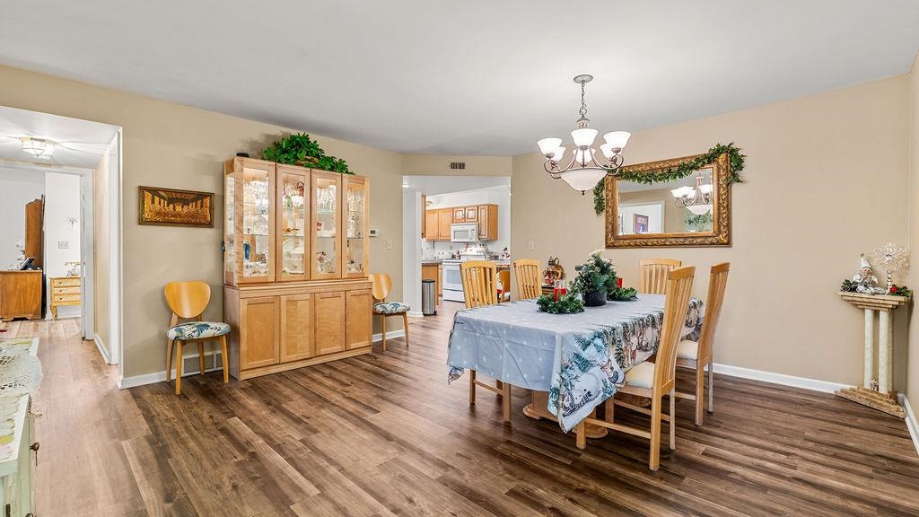 5548 Spring Brook Road, Unit 310 Rockford, IL 61114 - Photo 13 of 41 a view of a dining room with furniture window and wooden floor