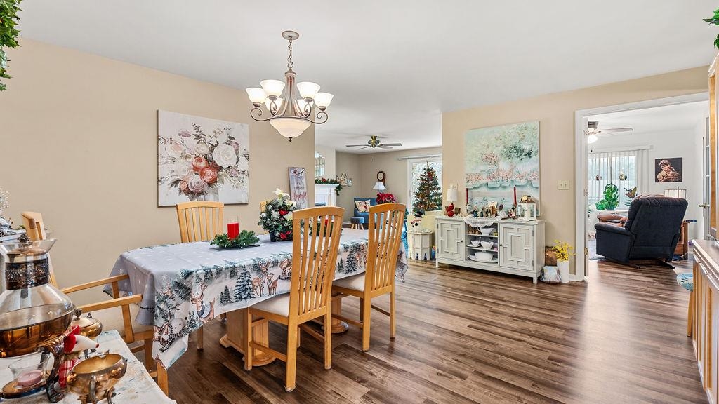 5548 Spring Brook Road, Unit 310 Rockford, IL 61114 - Photo 14 of 41 a view of a dining room with furniture wooden floor and a chandelier