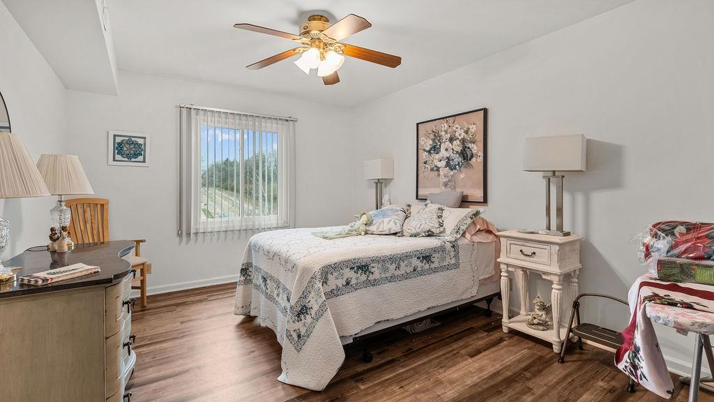 5548 Spring Brook Road, Unit 310 Rockford, IL 61114 - Photo 21 of 41 a bedroom with a bed and wooden floor