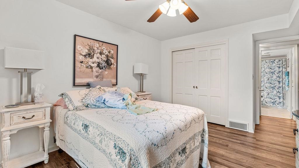 5548 Spring Brook Road, Unit 310 Rockford, IL 61114 - Photo 23 of 41 a bedroom with a bed and a chandelier