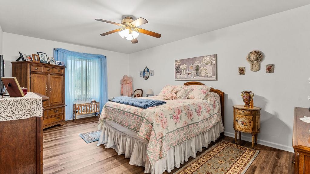 5548 Spring Brook Road, Unit 310 Rockford, IL 61114 - Photo 25 of 41 a bedroom with bed and a chandelier