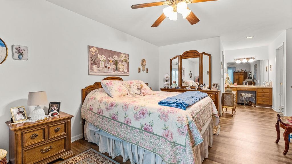 5548 Spring Brook Road, Unit 310 Rockford, IL 61114 - Photo 26 of 41 a bedroom with a bed and a chandelier