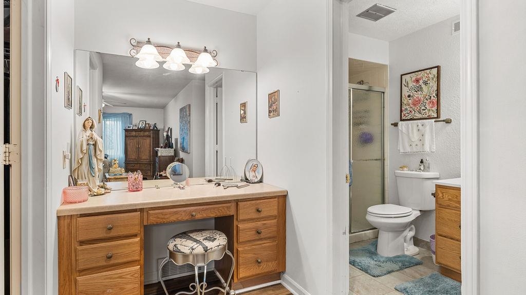 5548 Spring Brook Road, Unit 310 Rockford, IL 61114 - Photo 28 of 41 a bathroom with a sink vanity and a toilet