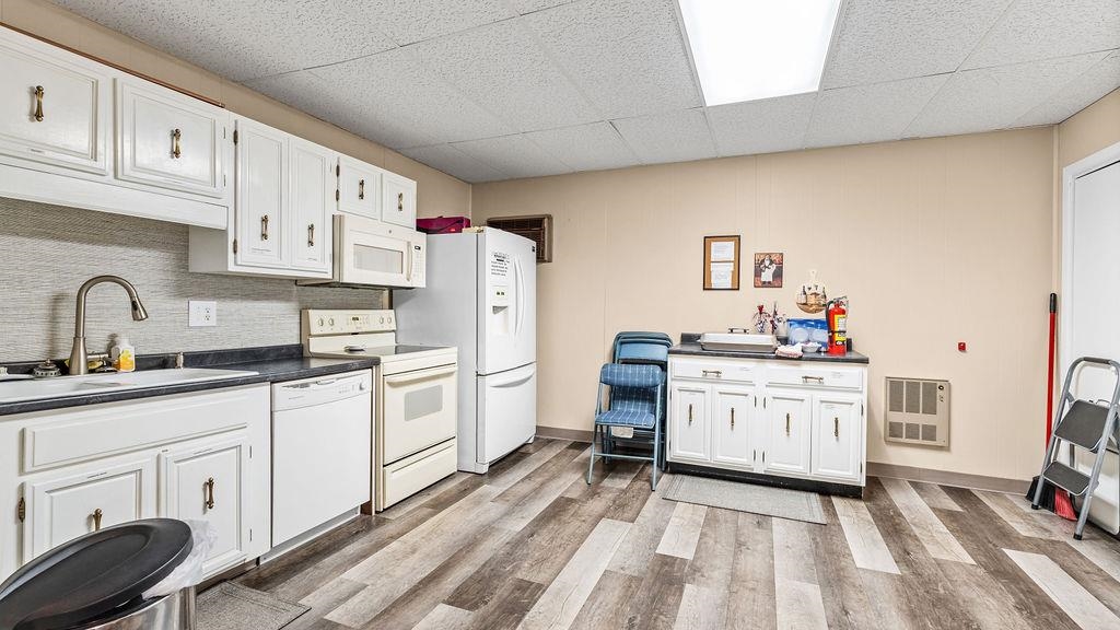 5548 Spring Brook Road, Unit 310 Rockford, IL 61114 - Photo 34 of 41 a kitchen with white cabinets and white appliances