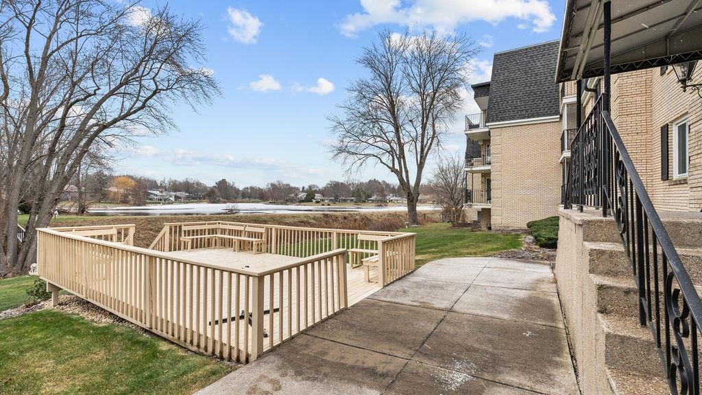 5548 Spring Brook Road, Unit 310 Rockford, IL 61114 - Photo 39 of 41 a balcony with wooden floor and fence