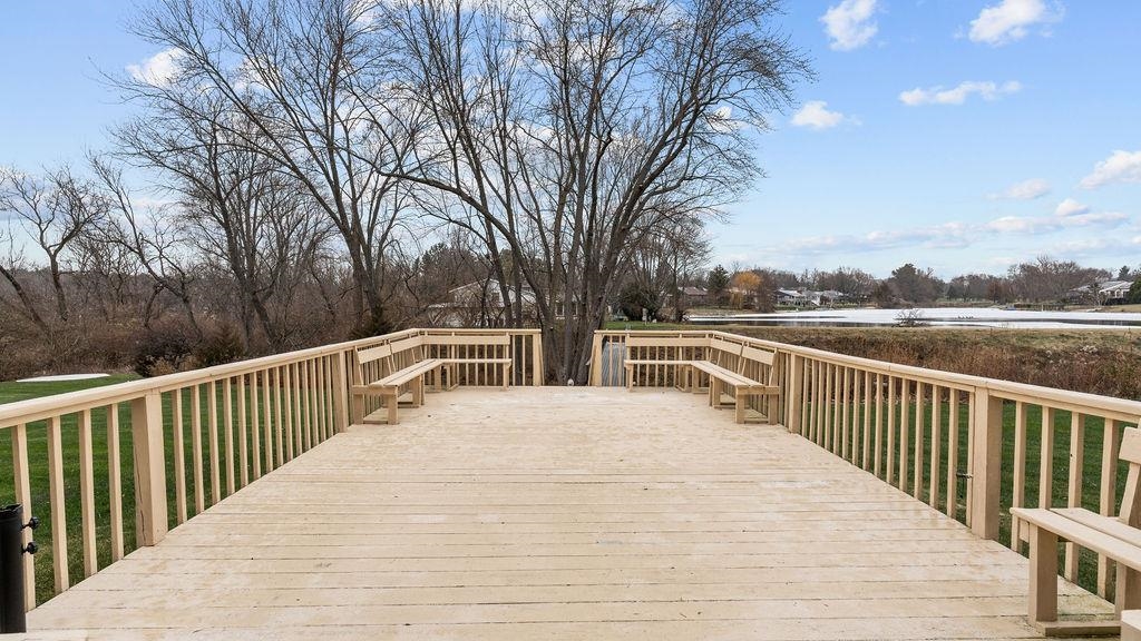 5548 Spring Brook Road, Unit 310 Rockford, IL 61114 - Photo 40 of 41 a view of balcony with wooden floor and fence and trees