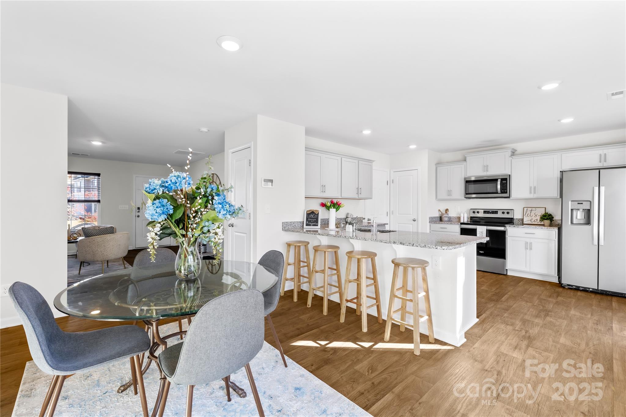 2721 Waybrook Drive Dallas, NC 28034 - Photo 7 of 33 a kitchen with microwave a refrigerator and chairs