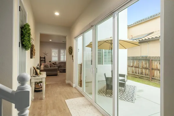 a living room with furniture and a floor to ceiling window