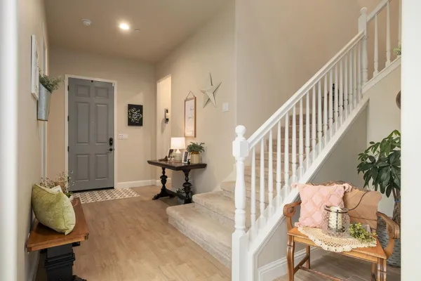 a spacious bedroom with a bed a couch and a window