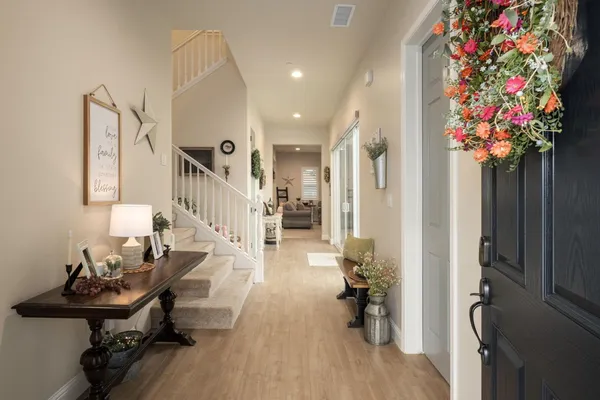 a very nice looking room with wooden floor and furniture