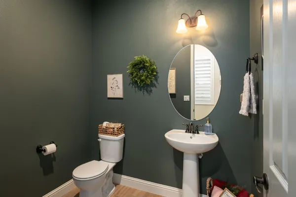 a bathroom with a toilet a sink and a mirror