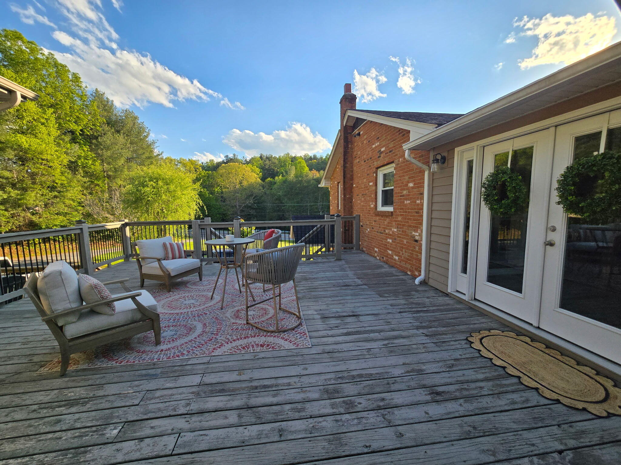 4003 Webbs Mill Road North Riner, VA 24149 - Photo 4 of 70 a view of a patio with dining table and chairs with wooden floor and fence