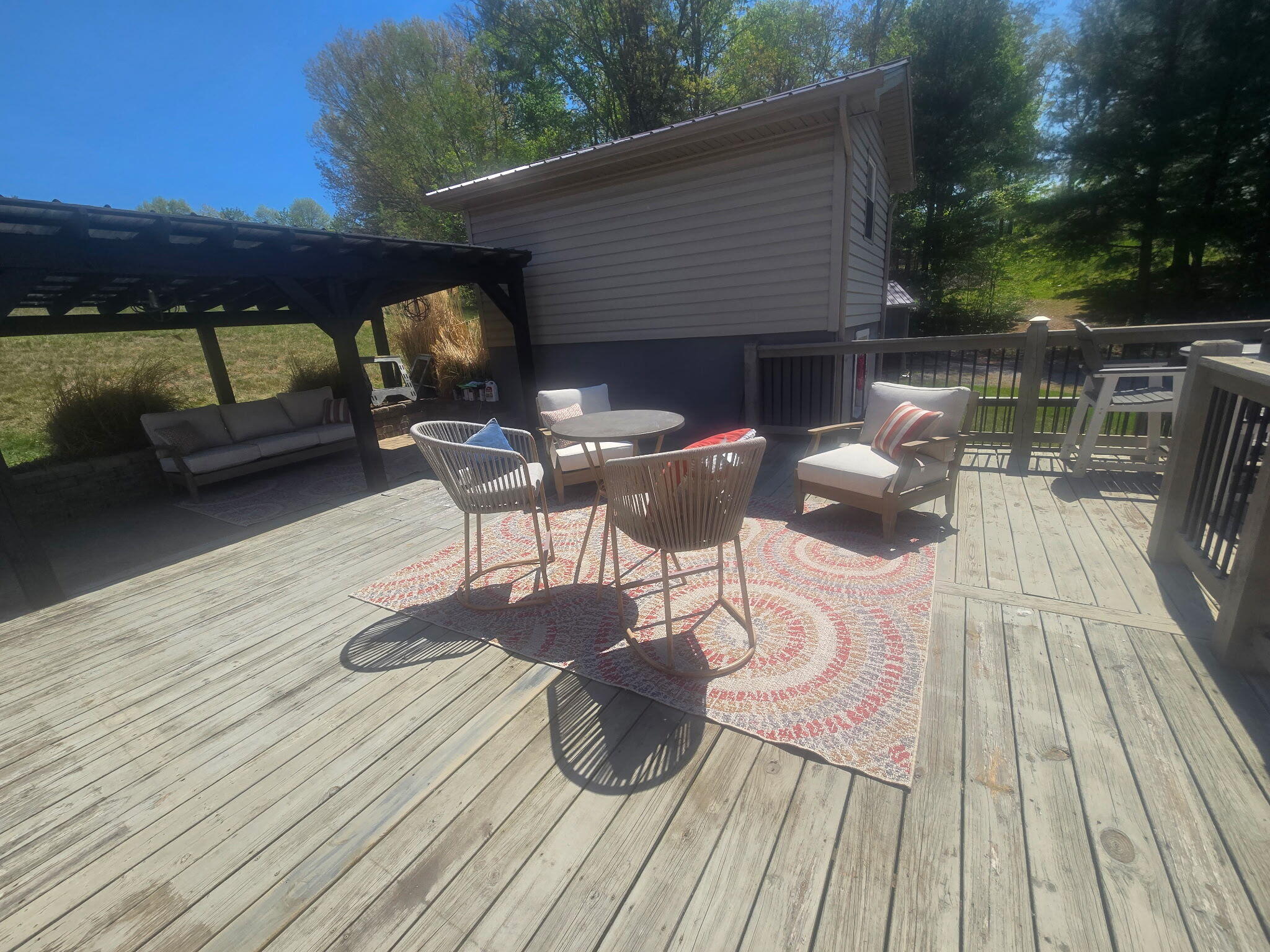 4003 Webbs Mill Road North Riner, VA 24149 - Photo 57 of 70 a view of deck with table and chairs under an umbrella with wooden floor