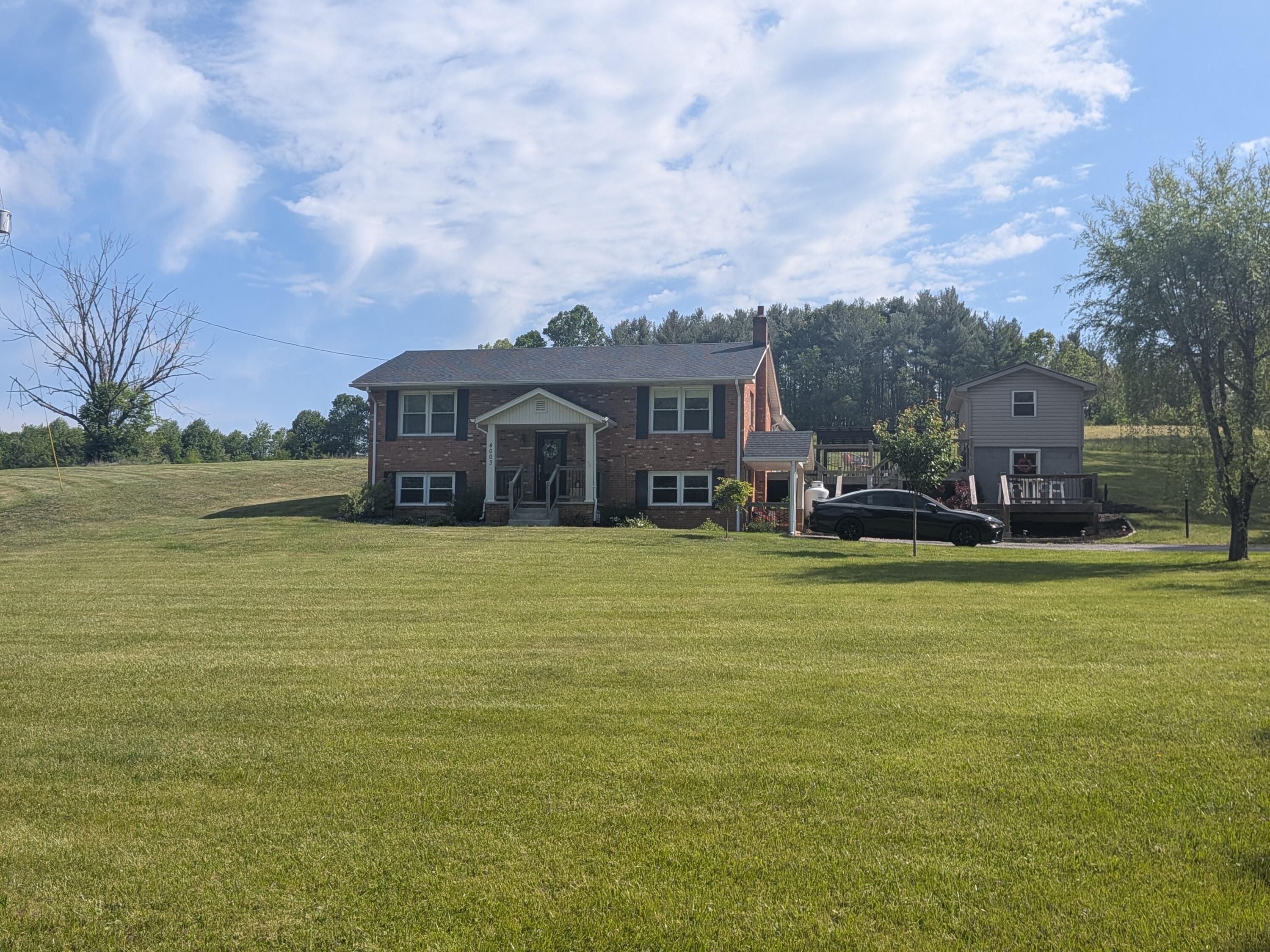 4003 Webbs Mill Road North Riner, VA 24149 - Photo 67 of 70 a front view of a house with a garden