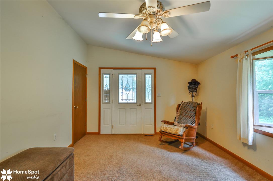 3795 Rhoades Road Kempton, PA 19529 - Photo 24 of 42 A welcoming entry featuring a decorative front door, vaulted ceilings, and plush carpet.