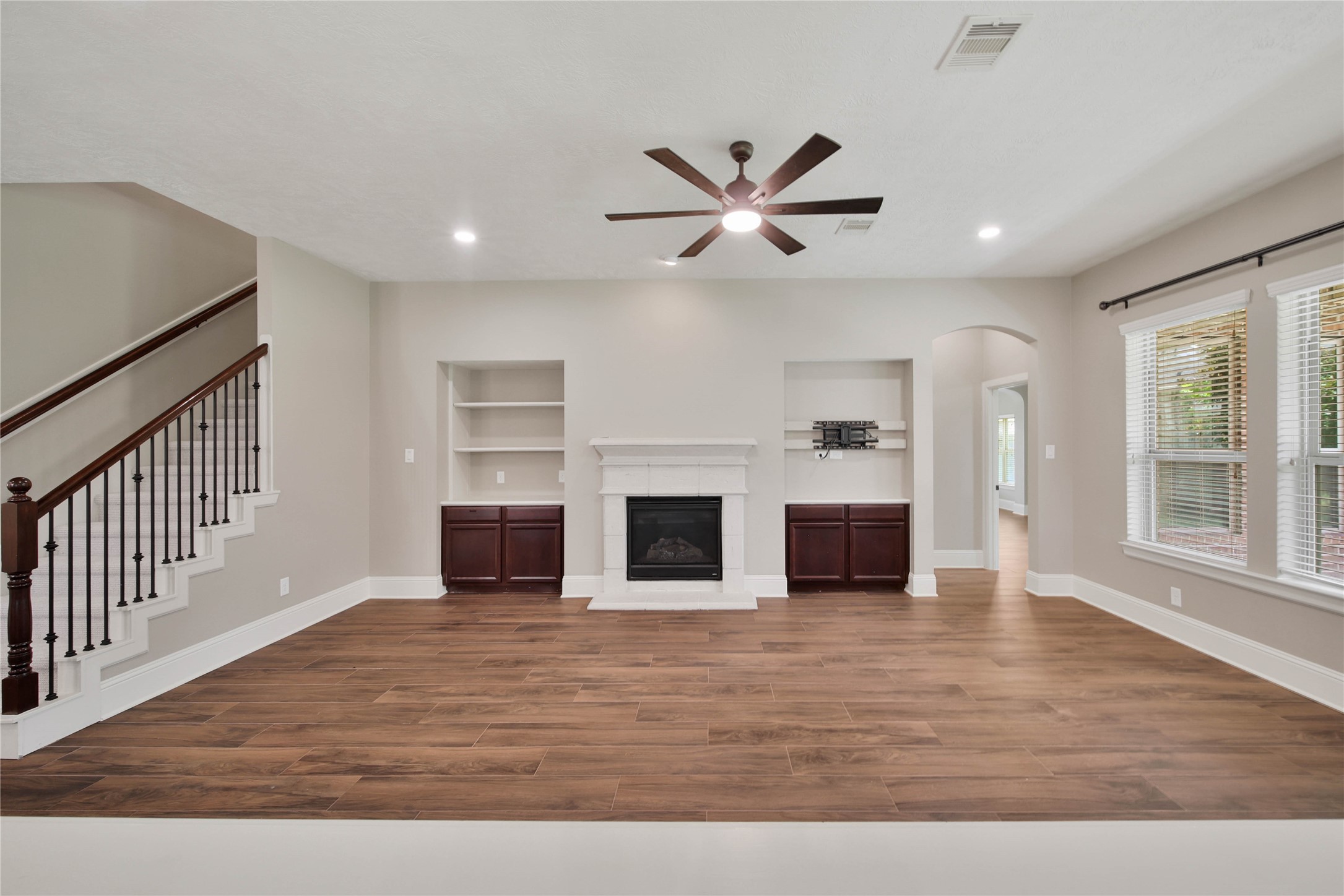 1215 Jake Springs Court Spring, TX 77386 - Photo 15 of 49 The gaslog fireplace flanked by two entertainment niches with discrete storage anchor the space.