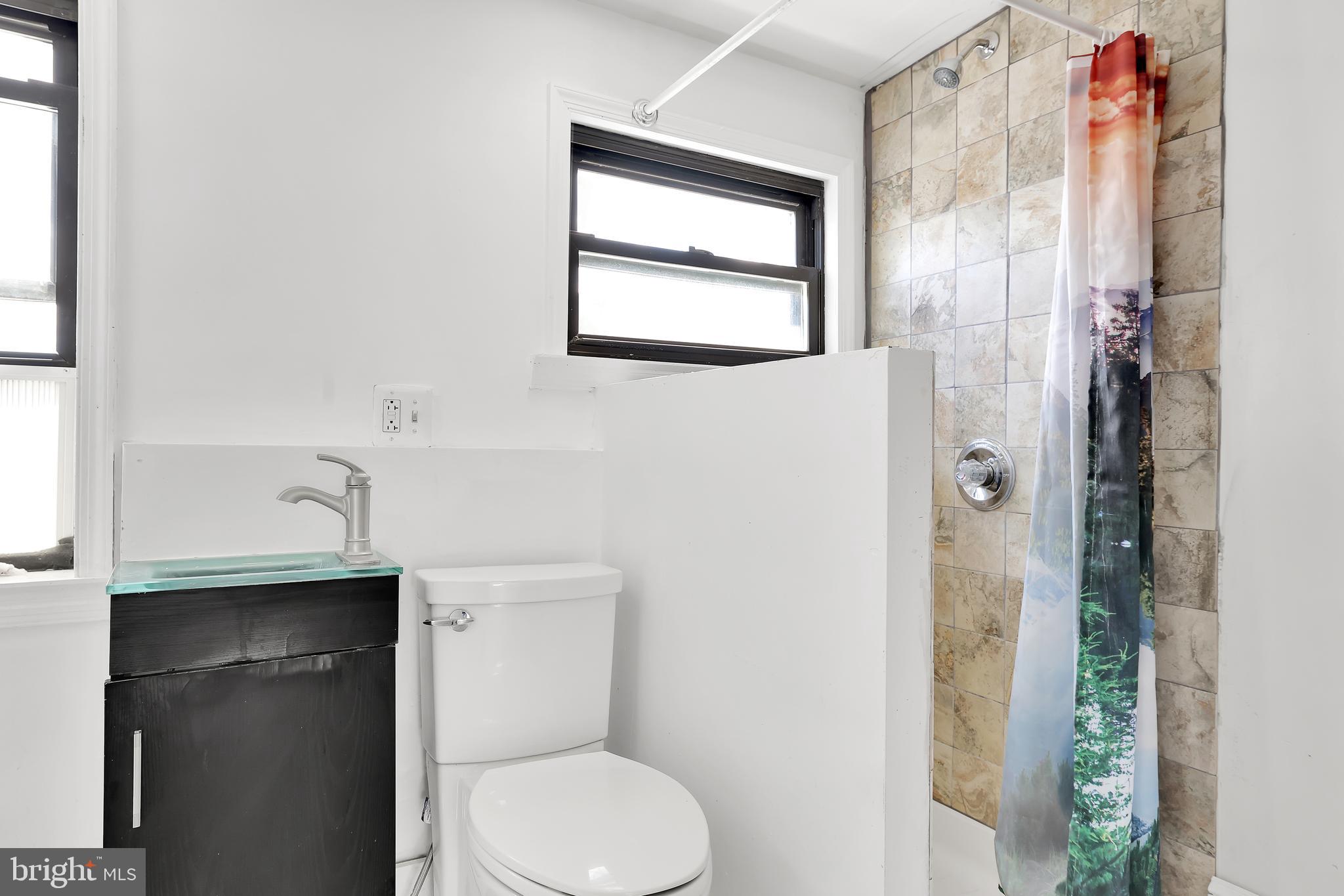 1828 California Street Northwest, Unit A Washington, DC 20009 - Photo 22 of 52 a bathroom with a toilet sink and shower