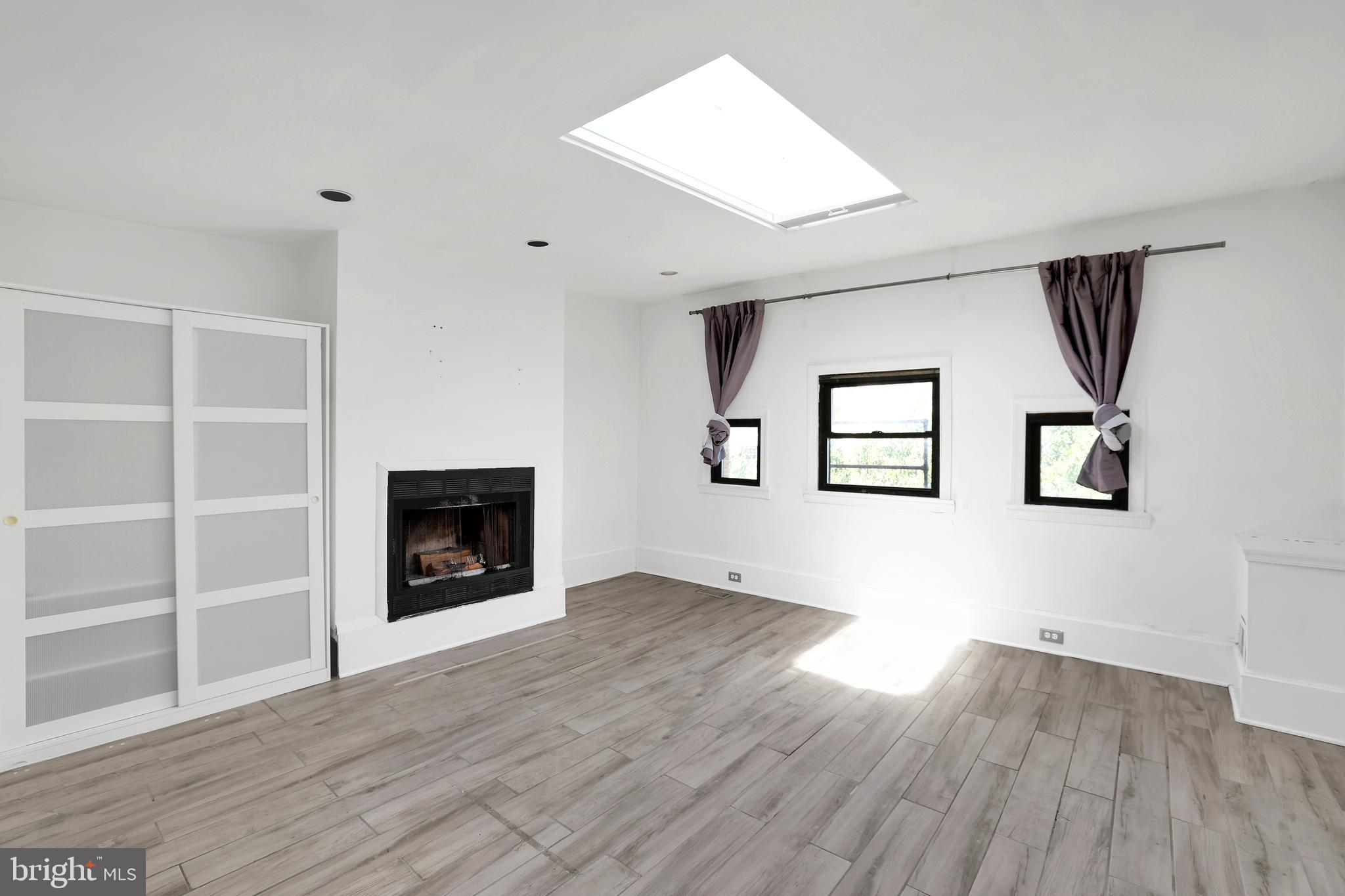 1828 California Street Northwest, Unit A Washington, DC 20009 - Photo 24 of 52 an empty room with windows and fireplace