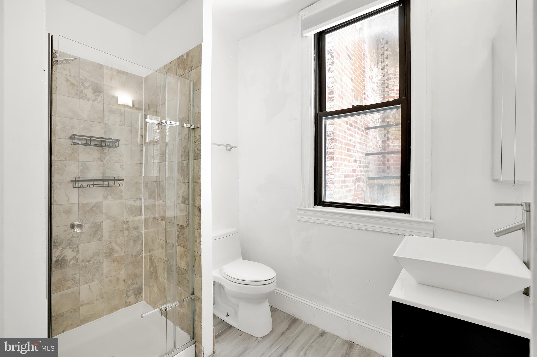 1828 California Street Northwest, Unit A Washington, DC 20009 - Photo 35 of 52 a bathroom with a toilet sink and shower