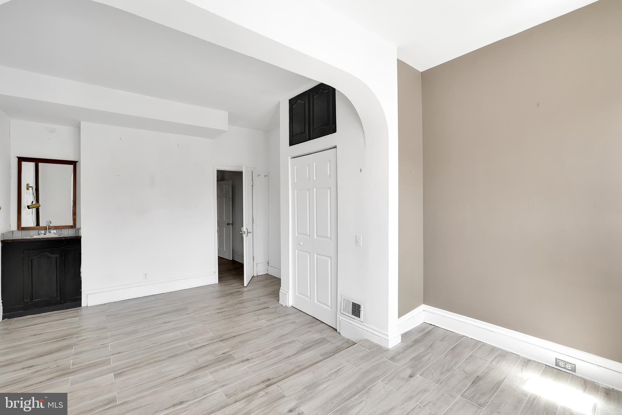 1828 California Street Northwest, Unit A Washington, DC 20009 - Photo 38 of 52 a view of an empty room with wooden floor and closet