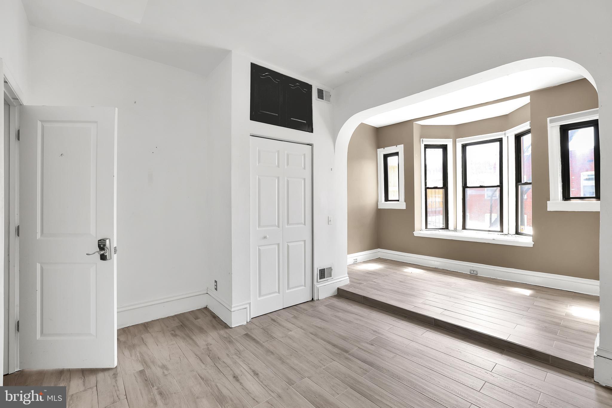 1828 California Street Northwest, Unit A Washington, DC 20009 - Photo 40 of 52 a view of an empty room with wooden floor and a window