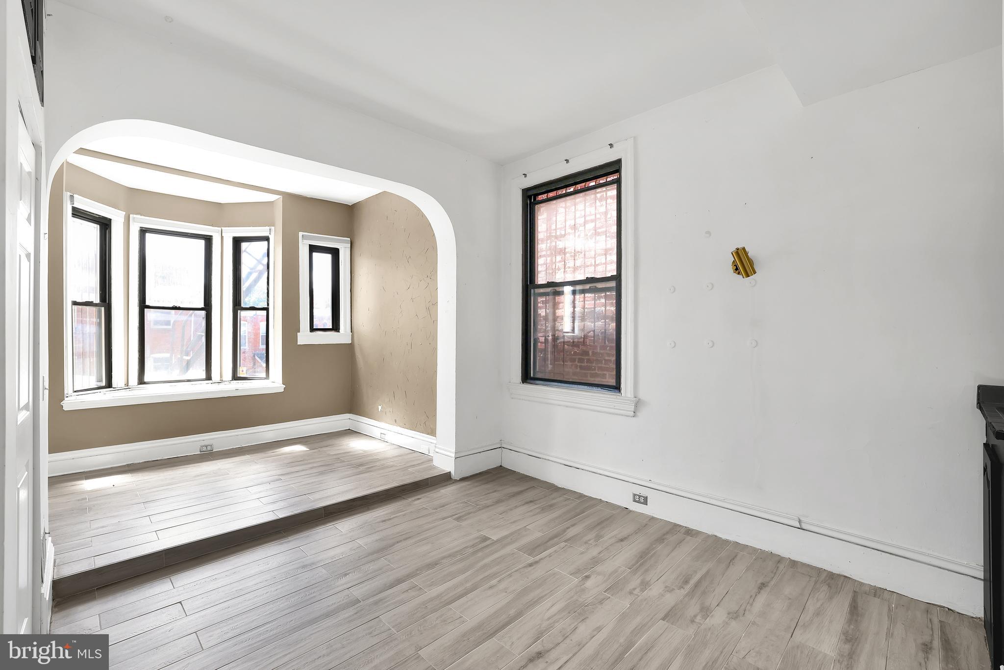 1828 California Street Northwest, Unit A Washington, DC 20009 - Photo 41 of 52 a view of an empty room with a window and wooden floor