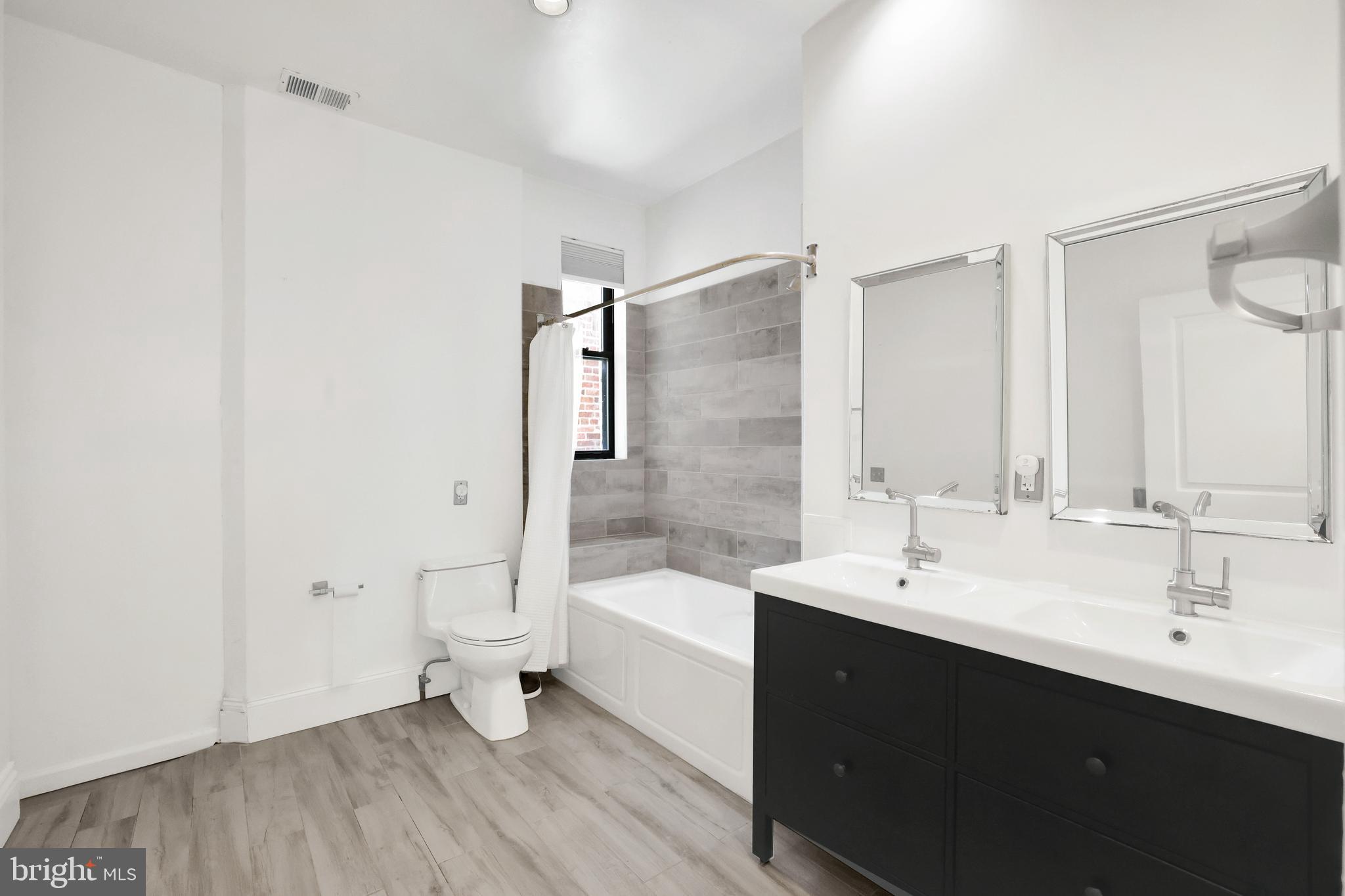 1828 California Street Northwest, Unit A Washington, DC 20009 - Photo 43 of 52 a bathroom with a double vanity sink toilet and bathtub