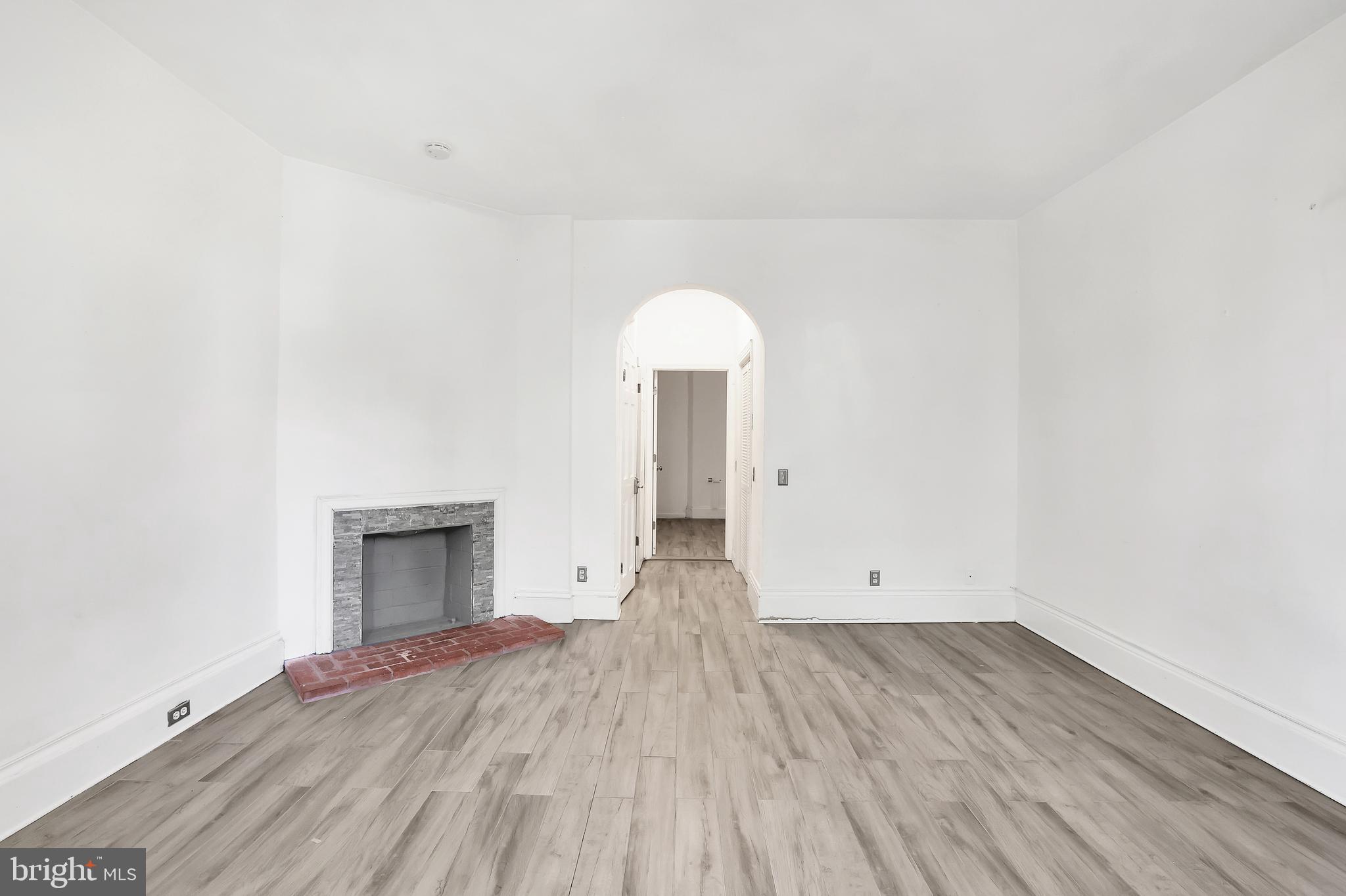 1828 California Street Northwest, Unit A Washington, DC 20009 - Photo 45 of 52 an empty room with wooden floor cabinet and windows