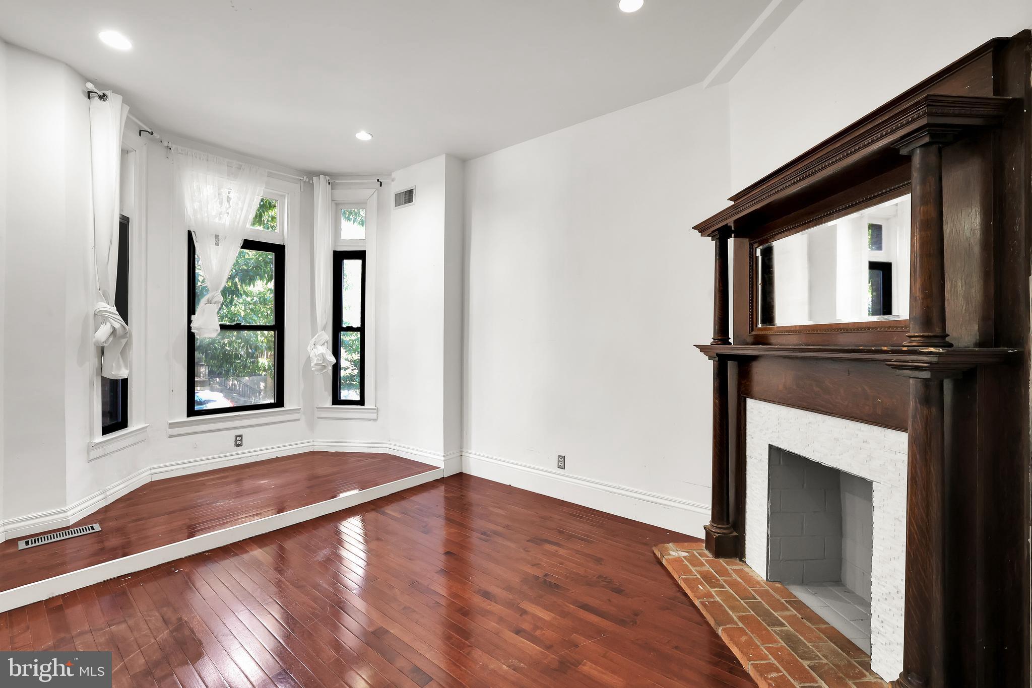 1828 California Street Northwest, Unit A Washington, DC 20009 - Photo 8 of 52 a view of an empty room with window and wooden floor