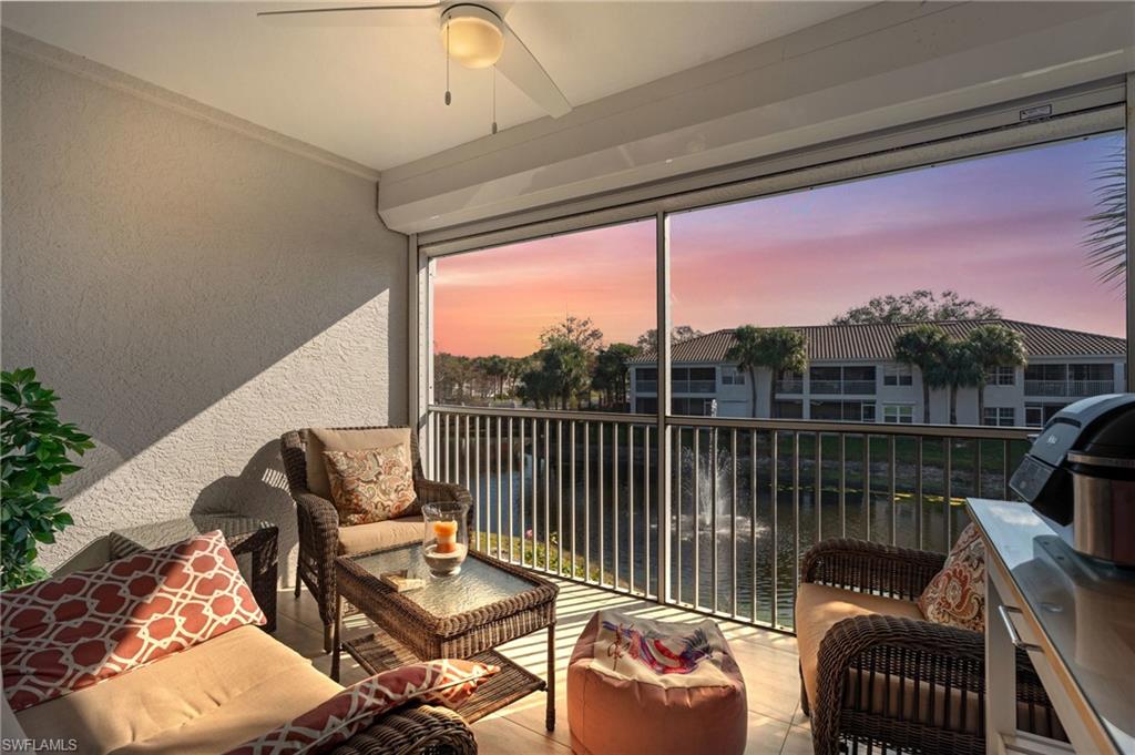 a balcony with wooden floor and outdoor seating