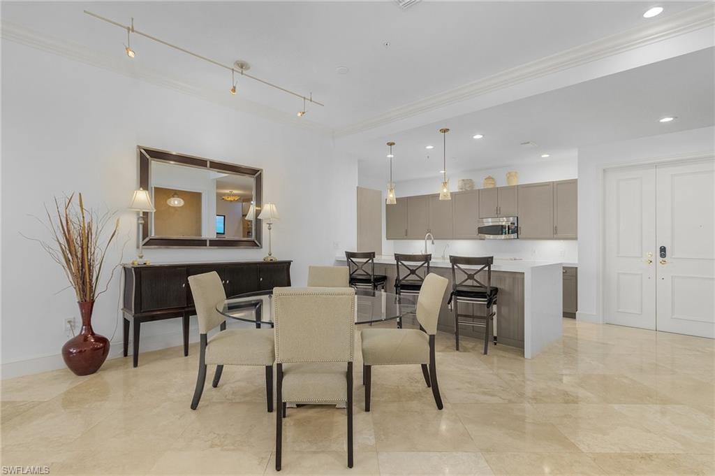 780 5th Avenue South, Unit 3 Naples, FL 34102 - Photo 13 of 28 a view of a dining room with furniture and a potted plant