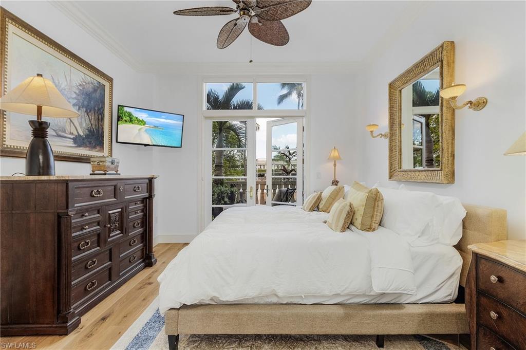 780 5th Avenue South, Unit 3 Naples, FL 34102 - Photo 14 of 28 a bedroom with a bed and a dresser